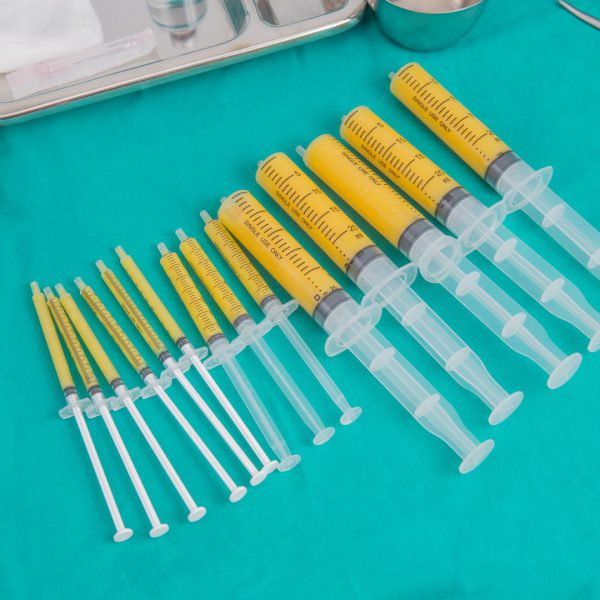 syringes of fat for fat grafing on steriled green fabric